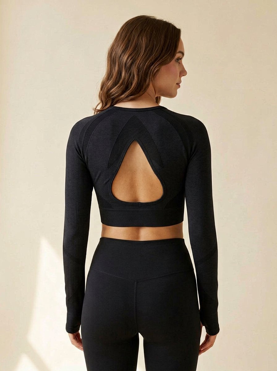 Sculpt Vital Long Sleeve Crop in black, arrowhead tonal panel and teardrop keyhole cutout on the back, back view